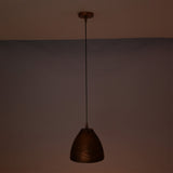 Sutton hammered bell pendant light casting a soft warm ambient glow while suspended from an adjustable black cord.