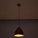 Hanging Sutton hammered bell pendant light with handcrafted copper shade and adjustable cord, providing warm task and ambient illumination.