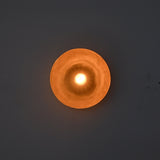 Front-facing illuminated view of the Sutton Modern Dome Wall Sconce emphasizing symmetrical light distribution and architectural form.