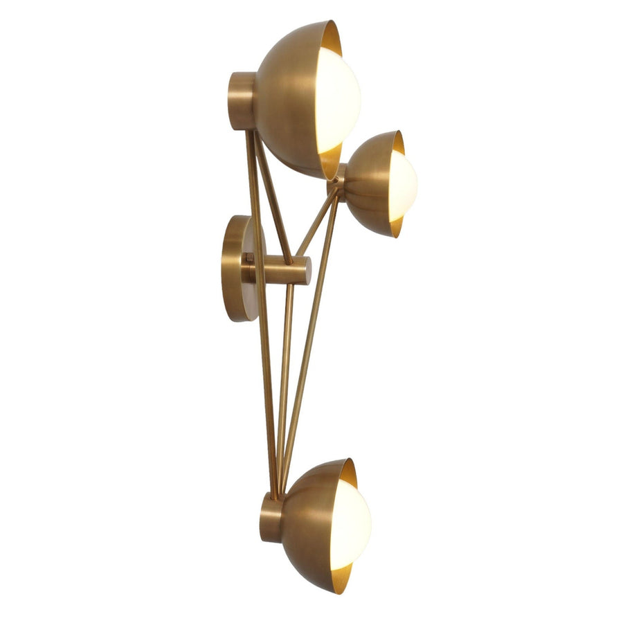 Modern brass wall lamp featuring three circular disc shades arranged in a triangular form, emitting a warm ambient glow for elegant wall lighting.