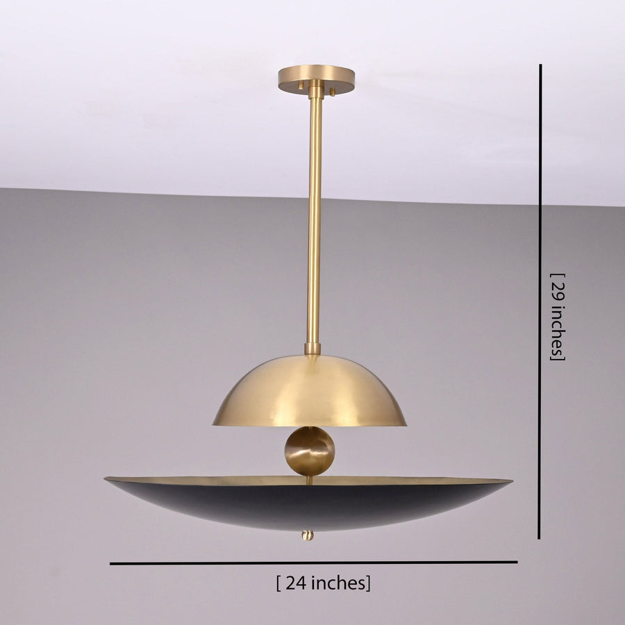 Venice Disc pendant installed above a round dining table, creating warm sculptural lighting in a modern dining room.