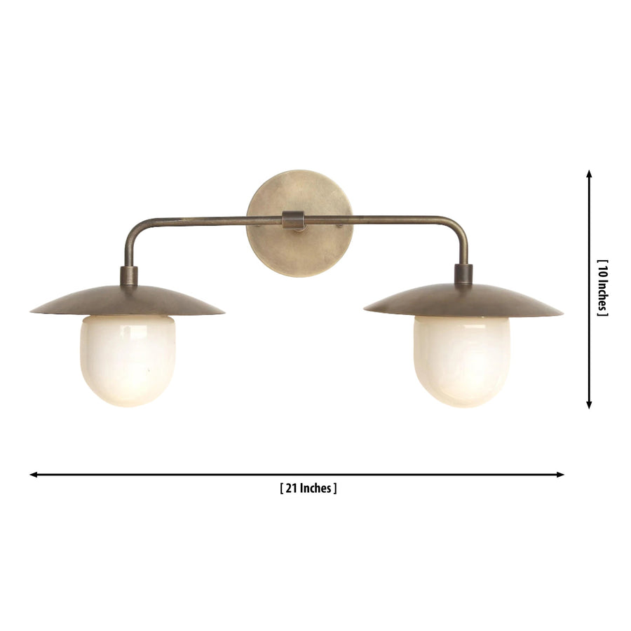 Verona dual dome vanity wall light installed above a bedroom console, providing warm ambient illumination with handcrafted bronze dome shades and opal glass globes.