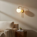 Verona brass globe wall sconce with curved arm and opal glass shade, front view – Model 32808