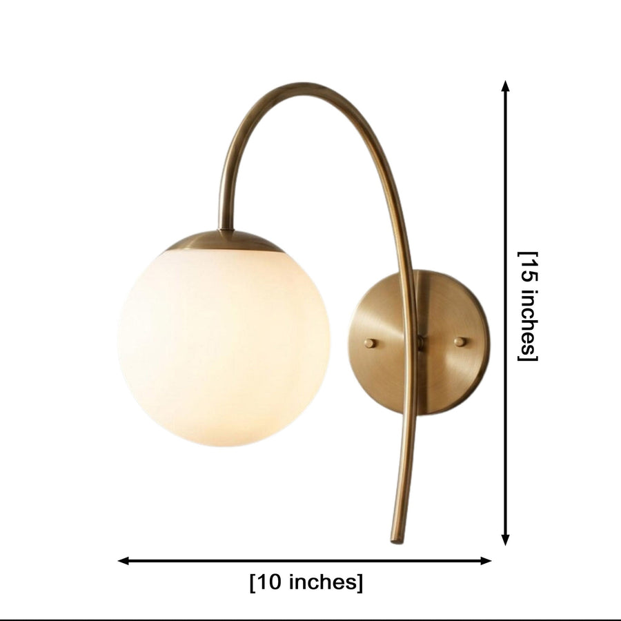 Verona Modern Globe Glass Wall Sconce installed in a cozy study, providing warm ambient illumination above a wooden desk and reading chair.
