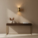 Angled view of Verona perforated cylinder wall sconce with round brass wall canopy and warm light, Model 32783.