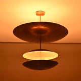 Close up of Verona Triple Saucer Chandelier highlighting the broad upper shade and warm layered glow.