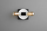 Modern wall light with white round disc backplate and black square base, twin horizontal Edison bulbs, minimalist contemporary sconce.