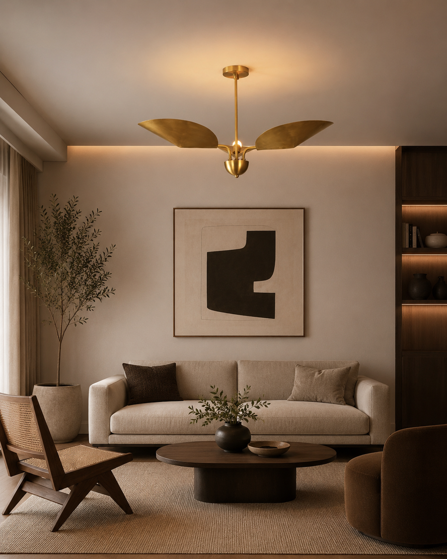 Willow sculptural leaf chandelier installed in a contemporary living room, providing elegant ambient lighting above a modern seating area.
