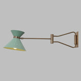 Adjustable brass swing arm wall lamp extended in opposite direction, highlighting flexible movement and balanced industrial design.