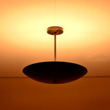 Ambient brass ceiling chandelier radiating soft warm light across the ceiling