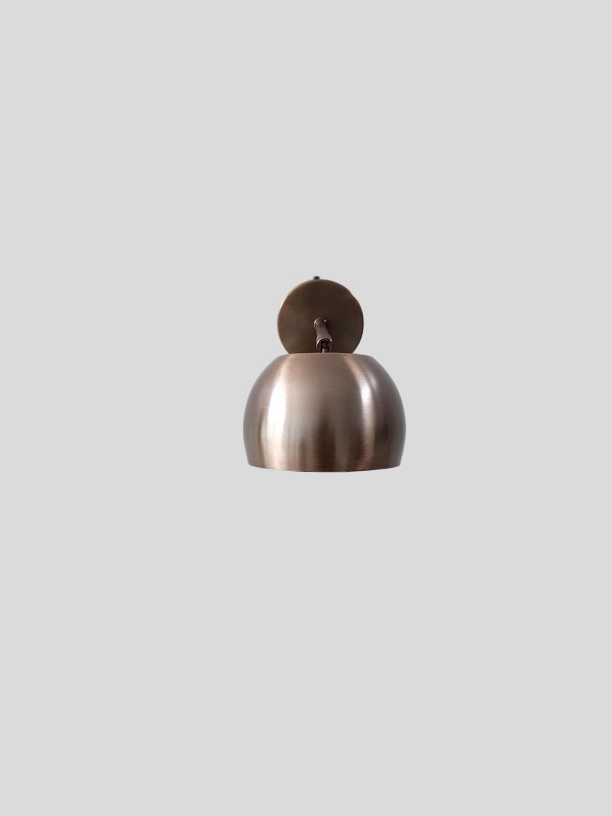 Front view of handcrafted antique patina brass wall lamp with brushed finish and minimalist styling