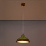 Artistic copper hanging pendant light with green patina finish, black suspension cord, and wide shallow dome shade