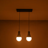 Angled illuminated view of the Aspen Dual Socket Pendant Chandelier with two glowing globe bulbs in a modern minimalist design.