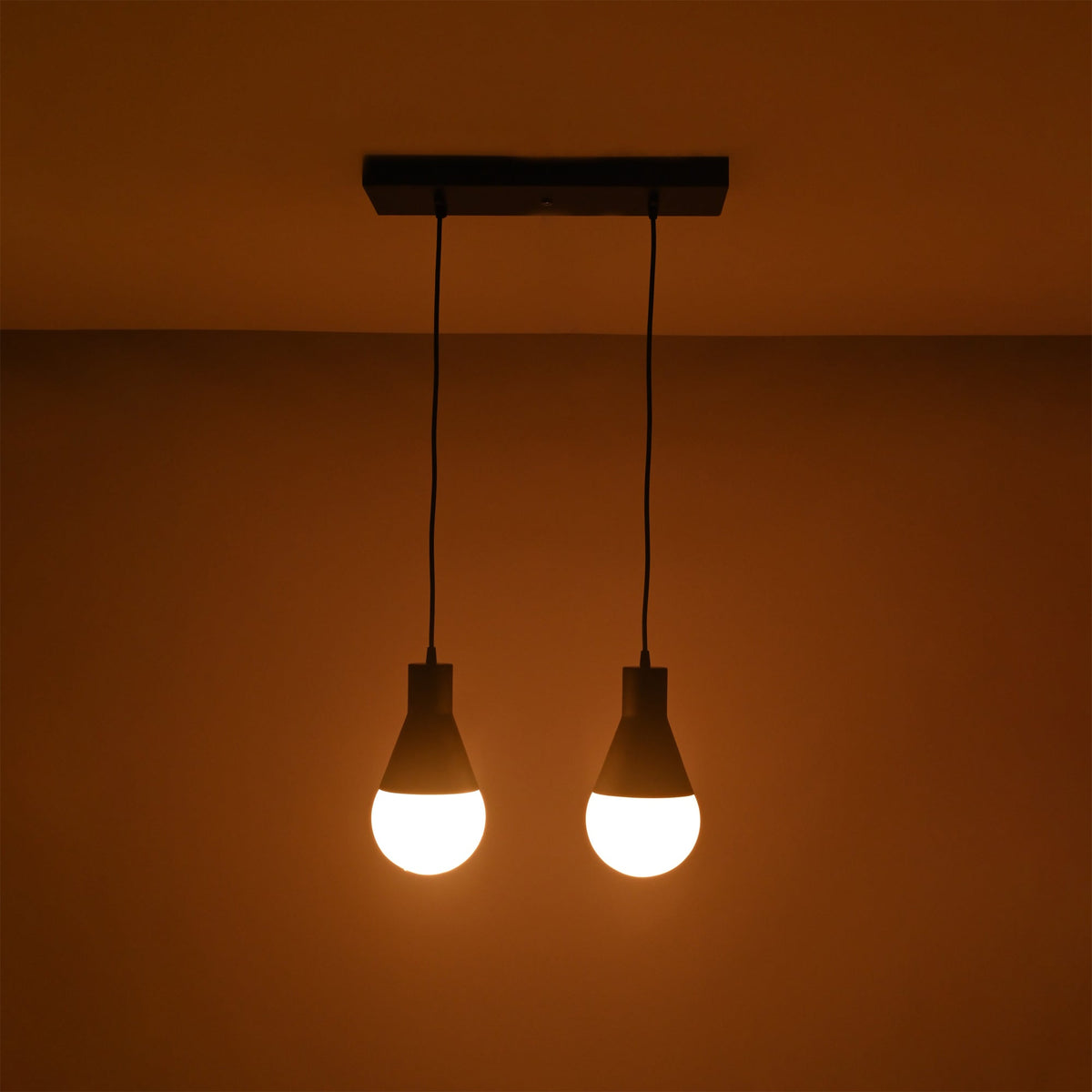 Close-up illuminated view of the Aspen Dual Socket Pendant Chandelier highlighting its dual pendant configuration and warm light output.