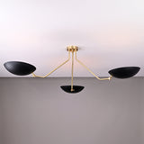 Front angled view of asymmetrical brass chandelier with matte black bowl shades and handcrafted brass rods.