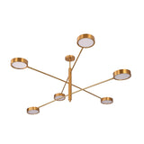 Athens 6-light linear disc chandelier shown in bedroom with warm ceiling illumination and modern brass design