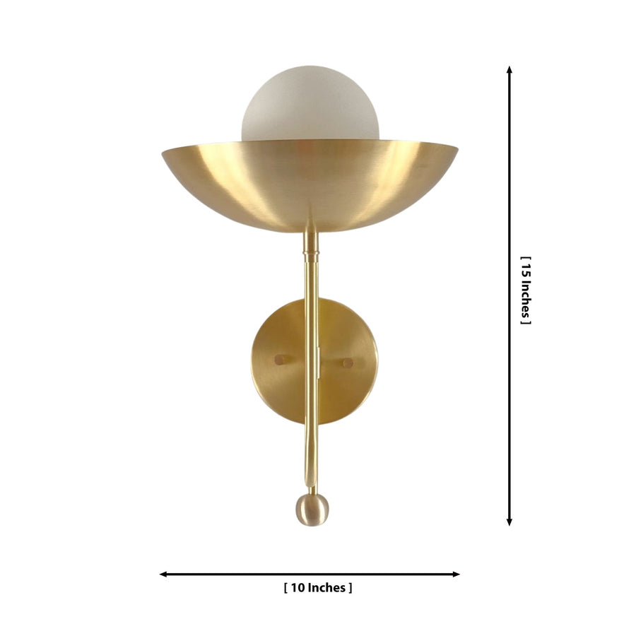 Aurora modern brass bowl wall sconce installed in a contemporary living room, providing warm ambient lighting above a wooden console table.