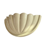 Front perspective of the Aurora modern ivory fluted half bowl wall sconce featuring a sculptural ribbed design and soft ivory finish.