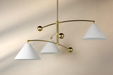 Handmade balance brass 3 light chandelier casting soft ambient glow in a refined modern space