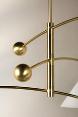 Detailed view of sculpted brass arms and spherical accents on handcrafted balance chandelier