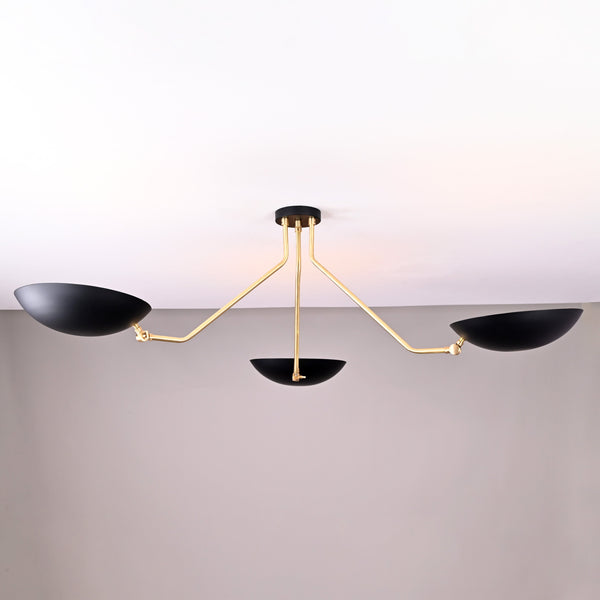 Front view of modern black and brass 3-light bowl chandelier with sculptural arms and matte black shades.