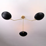 Top view of black and brass bowl chandelier showing elegant curvature of the brass arms and central support.