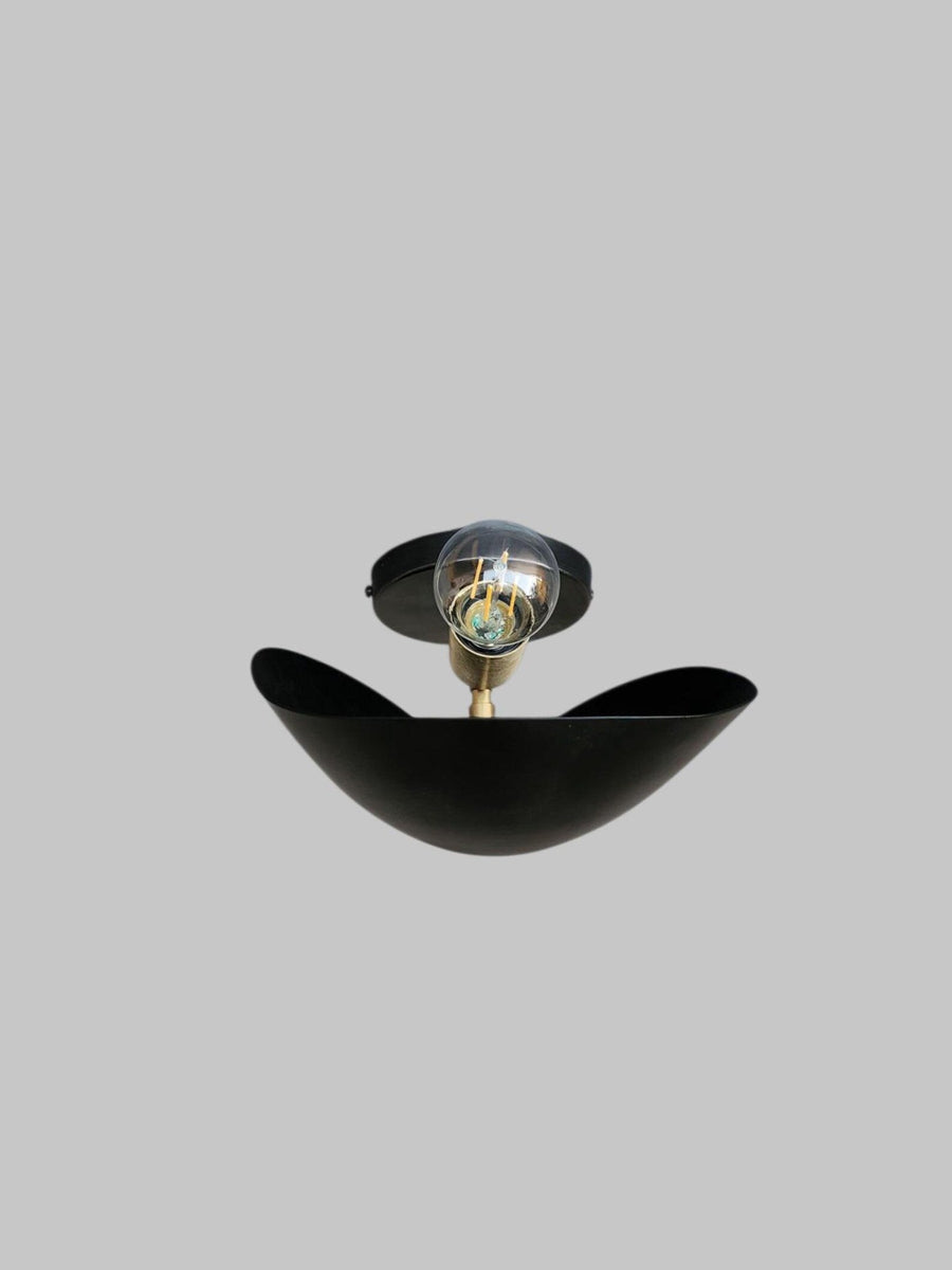 Side view of black brass leaf-shaped wall sconce by Brass Leaf Studio