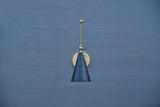 Brass wall-mounted light with black cone shade and adjustable arm