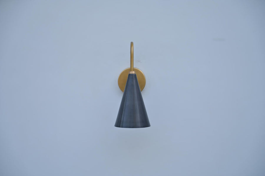 Modern brass wall sconce with black conical shade, handmade by Brass Leaf Studio for minimalist and industrial interiors