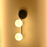 Blackened brass wall light with two frosted glass globes and a clean vertical profile for modern interior lighting