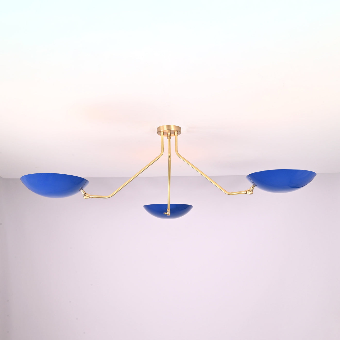Modern three-light flush mount ceiling light with blue bowl shades and brushed brass arms by Brass Leaf Studio
