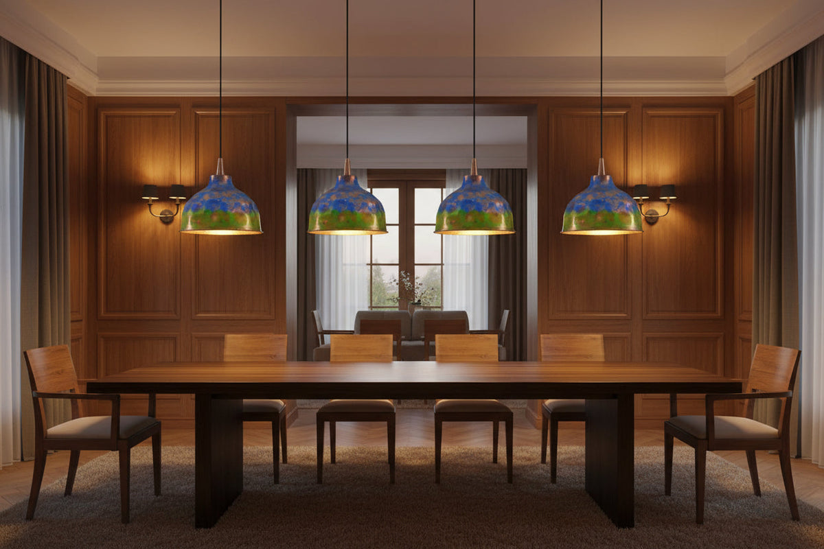 Blue green copper pendant light hanging above a dining table with warm glow and rustic modern style