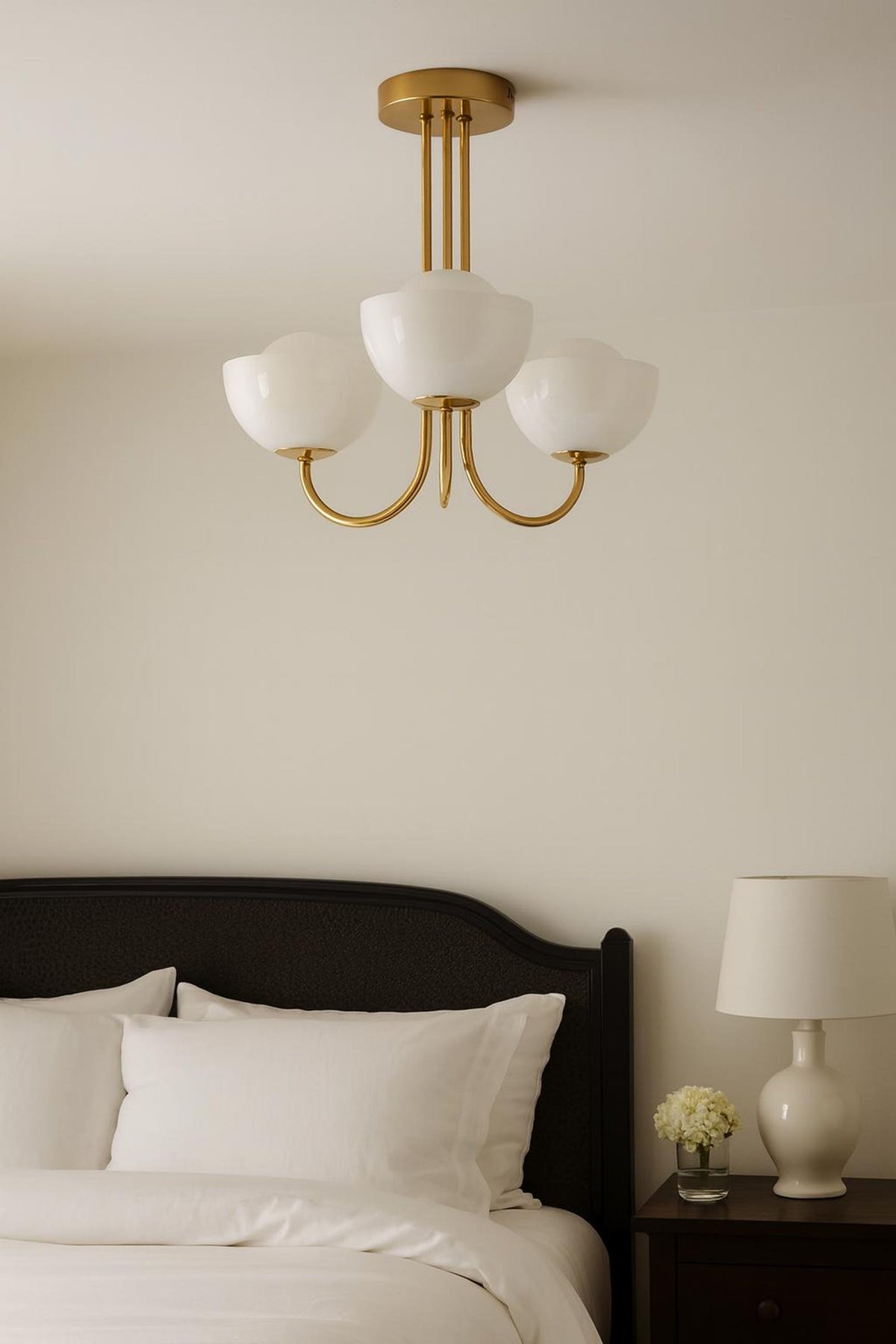Solid brass 3-light bowl glass chandelier installed above a bed with soft ambient bedroom lighting