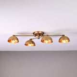 Handmade brass ceiling light with four dome-shaped shades illuminated, modern low-profile 4-light fixture for living room or hallway.