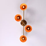 Overhead view of four-light brass bowl shade chandelier spreading ambient warm light, handcrafted flushmount fixture.