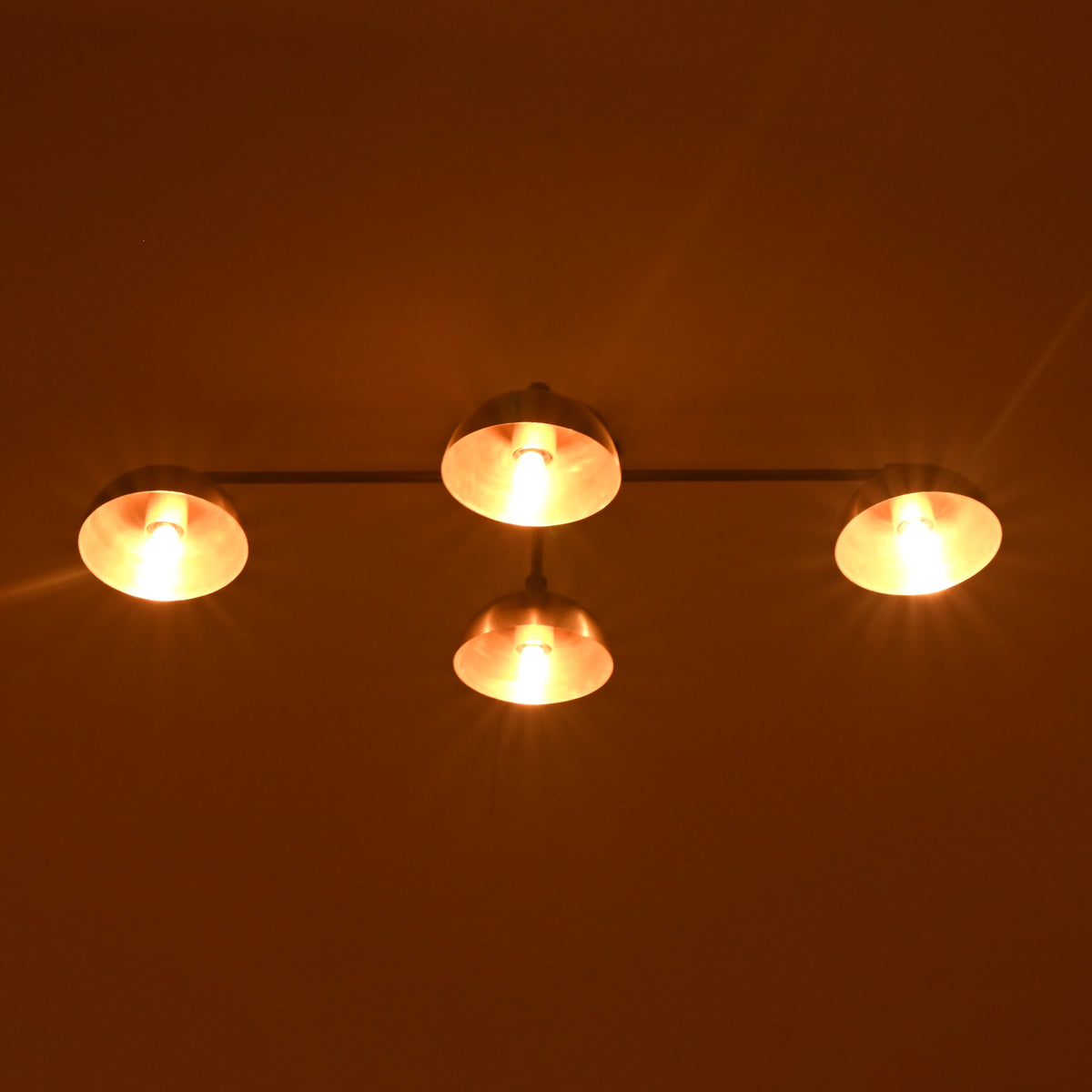 Brass mid-century style 4-light flushmount chandelier with warm ambient lighting and elegant brushed brass shades.
