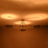 Warm ceiling reflections created by polished chrome brass bowl ceiling light with indirect lighting design.