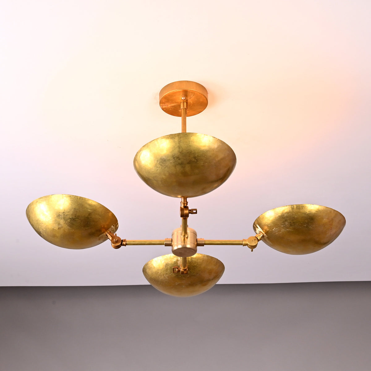 Front view of 4-bowl hammered brass chandelier with solid brass frame, showcasing handcrafted texture and warm reflective finish.