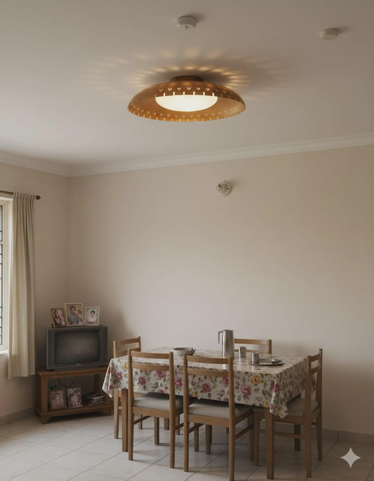 Brushed brass bowl flush mount ceiling light installed in a dining room creating soft ambient and decorative uplighting