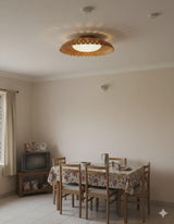 Brushed brass bowl flush mount ceiling light installed in a dining room creating soft ambient and decorative uplighting