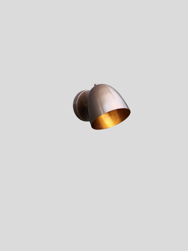 Front view of antique patina brass wall light with warm brushed finish by Brass Leaf Studio