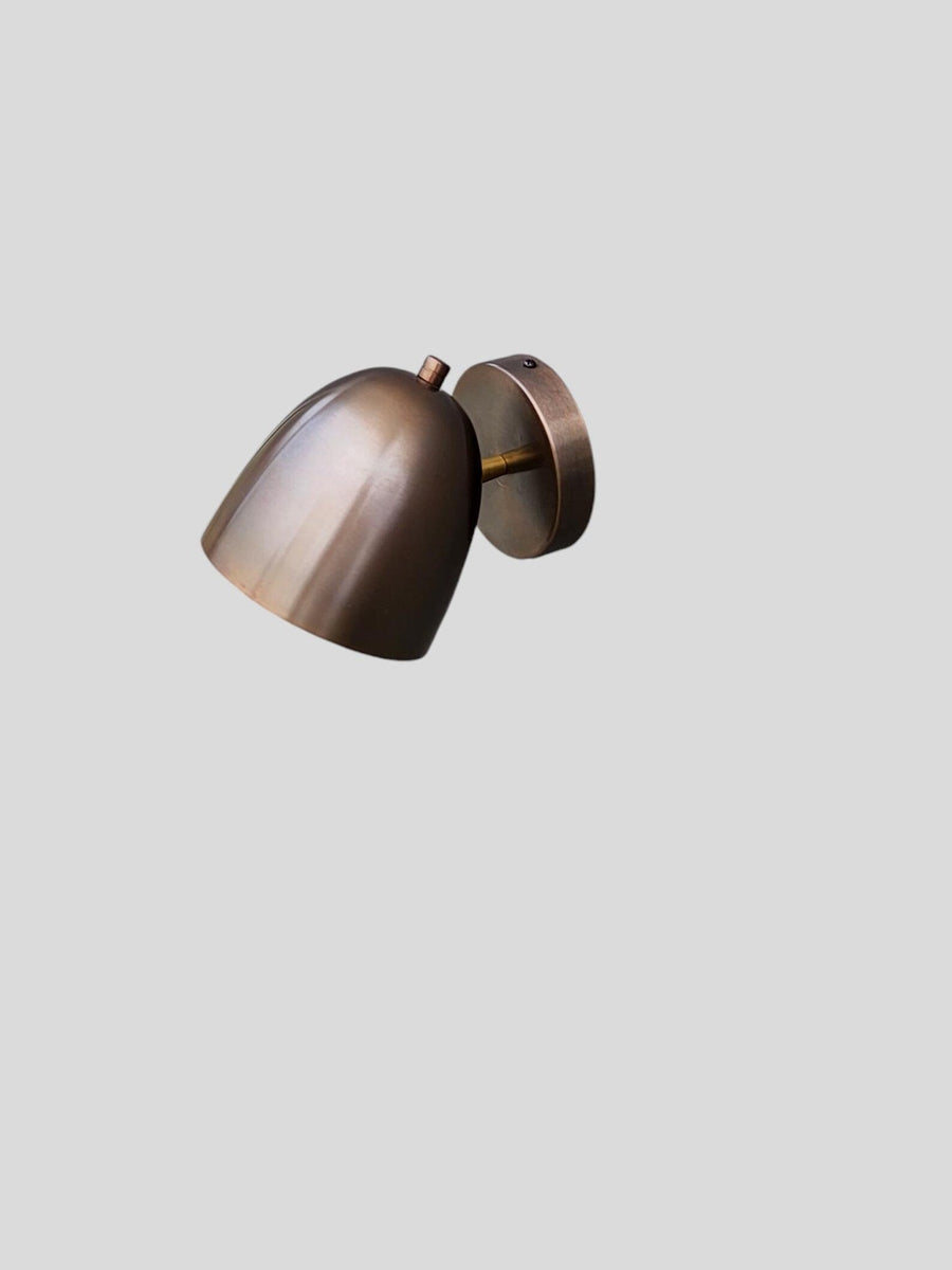 Front view of antique patina brass wall light with warm brushed finish by Brass Leaf Studio