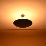 Warm ambient glow from 5-light brass ceiling chandelier – uplighting design