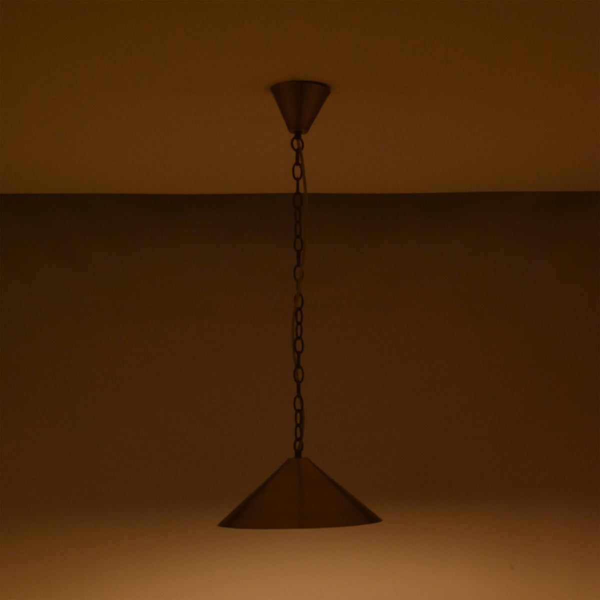 Brass cone pendant light on white background showing chain suspension, ceiling canopy, and wide shade design