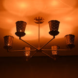 Close-up of perforated brass cone shade showing intricate light diffusion and handcrafted detailing.