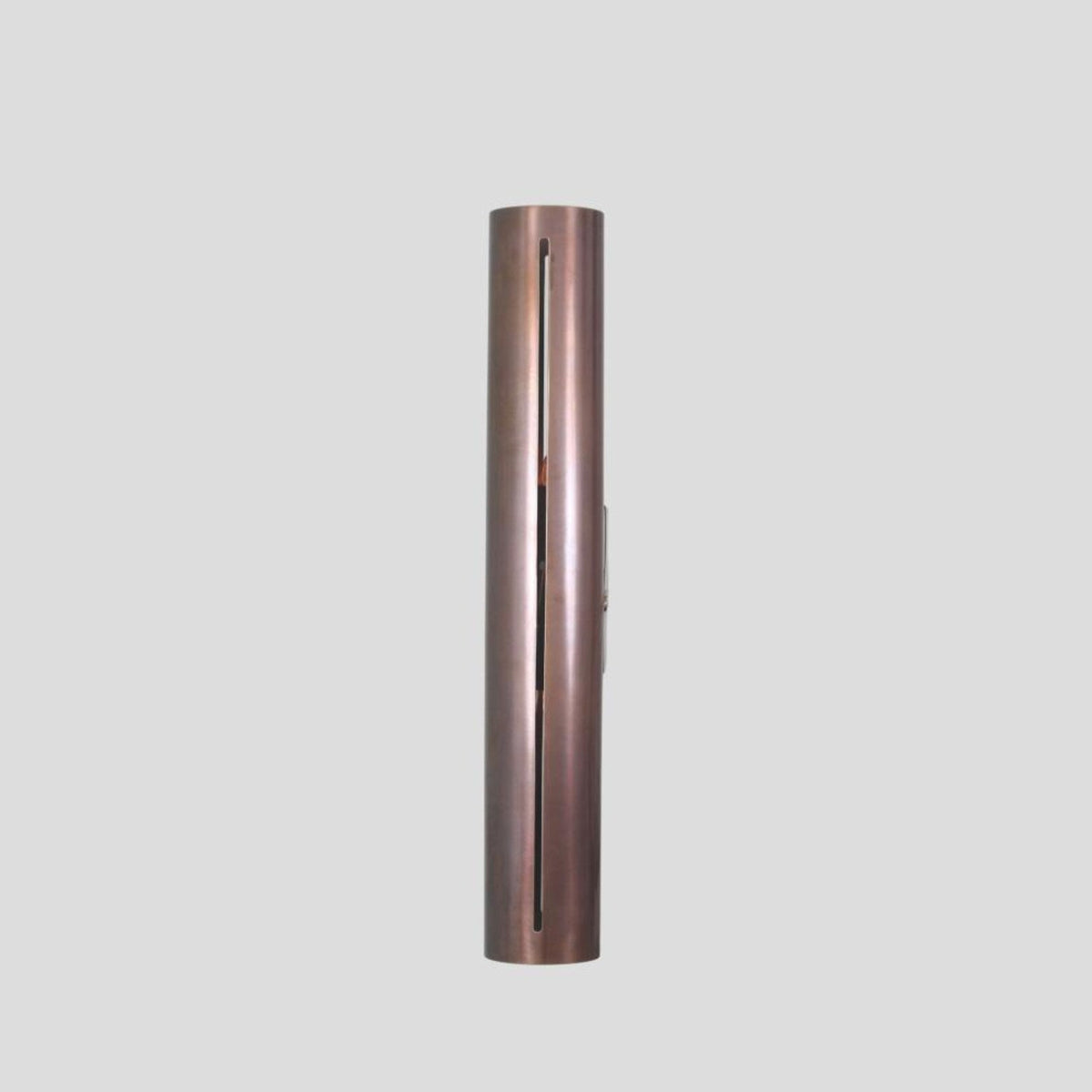 Slim vertical profile of handmade brass wall sconce, showcasing sleek industrial design with elongated cut detail.