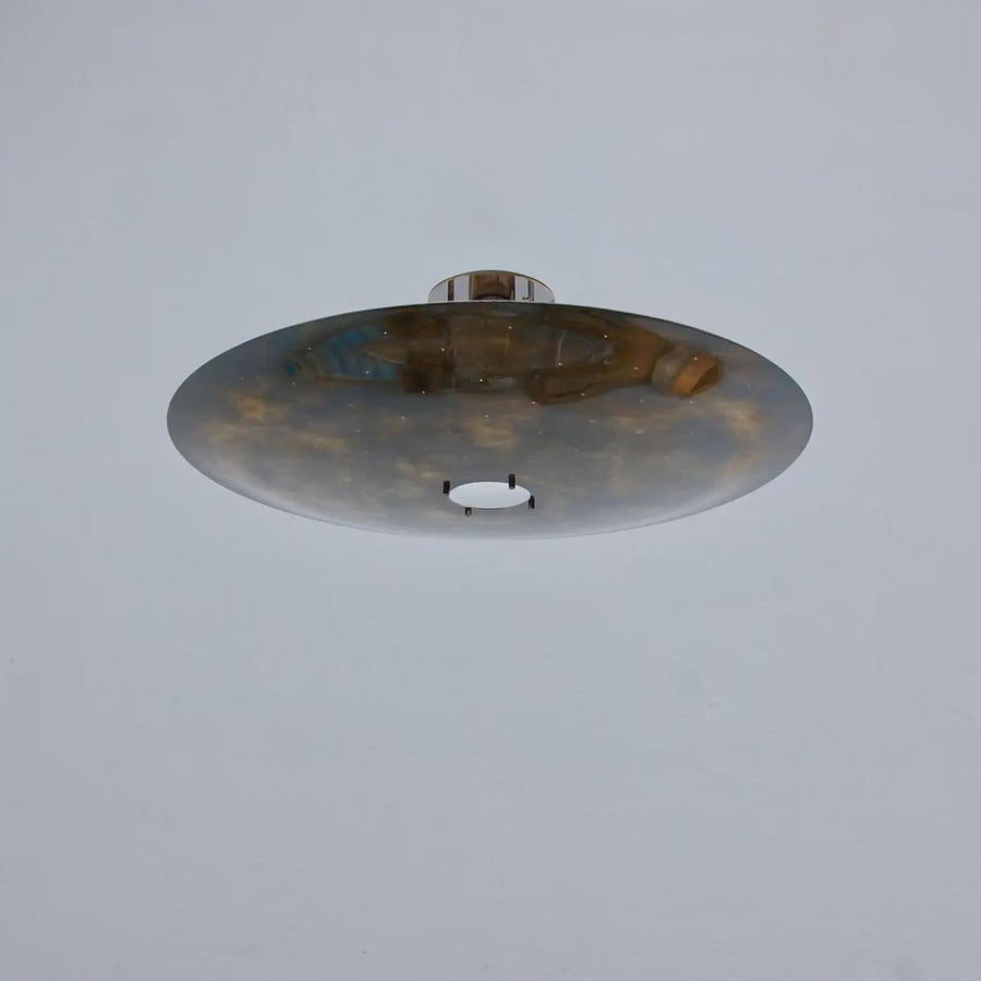 Sculptural brass disc flush mount ceiling light with wide bowl shade and warm indirect glow, handcrafted in solid brass by Brass Leaf Studio.