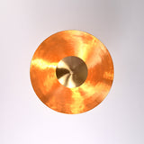 Top view of brass disc ceiling chandelier with polished inner surface and central brass dome
