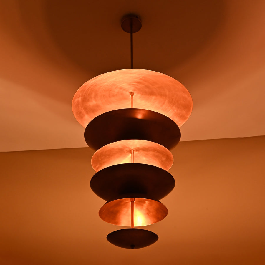 Handmade 9-light brass disc chandelier featuring cascading dome layers in brushed copper finish against beige background
