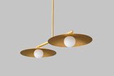 Angled view of handcrafted brass disc chandelier with soft glass globe diffusers